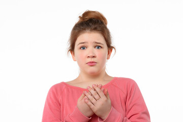 Worried young girl standing white background with a frightened expression on her face. Human...