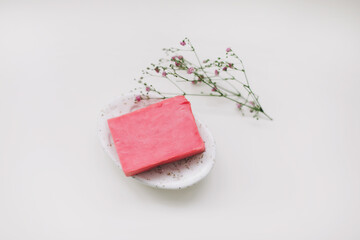 Natural handmade soap bar with ceramic soap dish and flowers, spa organic soap, sustainable lifestyle