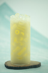 A glass of fermented milk drink with ice.