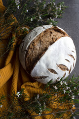 Artisan bread on gray background with copy space. Homemade sourdough bread recipes. Healthy eating concept. 