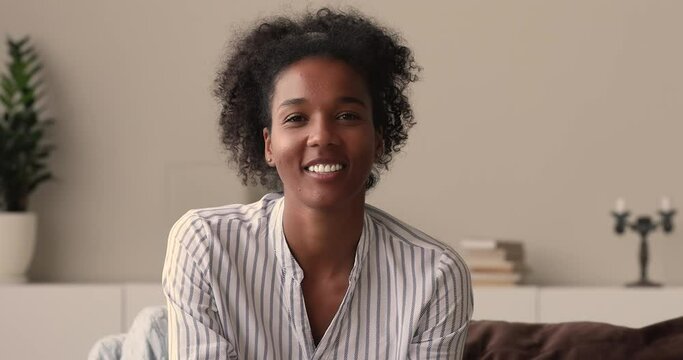 Web camera head shot view happy candid african american woman holding video call conversation, communicating distantly with friends, enjoying pleasant talk, speaking chatting sharing life news online.