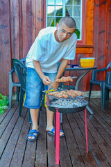 Cool Russians grill shashlik in nature. Russian specialties.