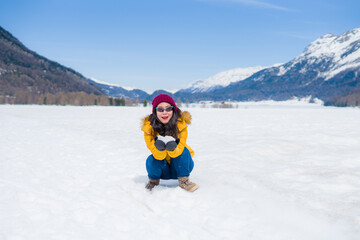 Fototapeta na wymiar winter lifestyle portrait of young happy and attractive Asian Chinese woman at beautiful snow mountains landscape enjoying Easter holidays in Swiss Alps smiling cheerful