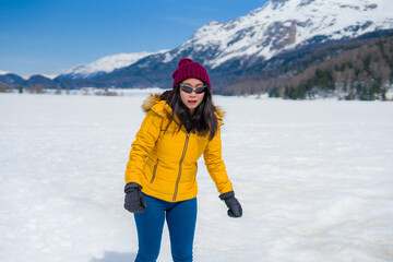 Fototapeta na wymiar winter lifestyle portrait of young happy and attractive Asian Korean woman at beautiful snow mountains landscape enjoying Easter holidays in Swiss Alps