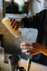 Bartender using bottle with aquafaba.