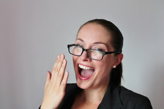 Attractive good looking Business woman in glasses laughing and smiling with copy space 