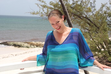 plus size curve woman model on beach resort balcony in swimsuit and kimono and palm trees 