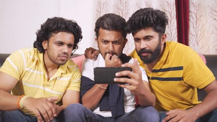 Three friends shouting and creaming while watching live streaming sports on mobile phone - concept of sport fans support, enjoyment, technology and internet