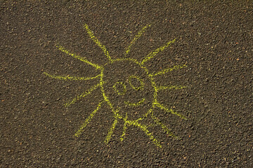 simple chalk drawing of smiling sun on pavement