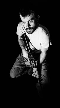 Portrait of an American Army veteran holding an AR15 Rifle.