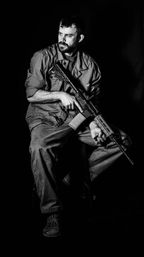 Portrait of an American Army veteran holding an AR15 Rifle.