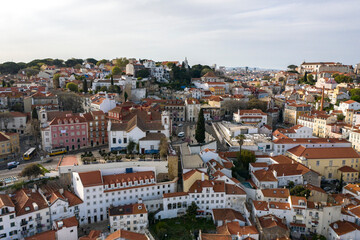 Fototapeta na wymiar Aerial drone view over Alfama District, Lisbon, Portugal. Lockdown cityscape. São Jorge Castle in the background.
