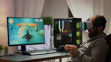 Pro cyber sport gamer wining playing video games using vr headset. Virtual space shooter game championship in cyberspace, esports player performing on powerful computer during gaming tournament