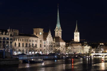 Naklejka na ściany i meble Illuminated old town city of Zurich by night. Photo taken April 9th, 2021, Zurich, Switzerland.