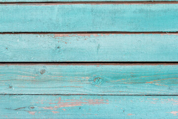 old wooden wall painted blue, weathered wooden background with nails and slits