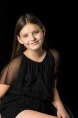 Naklejka premium Cute long haired girl posing half turned to camera