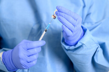 Doctor holding a syringe with a single bottle vial of Covid-19 vaccine. Concept fight against virus. Close up detail. Medical concept vaccination hypodermic injection treatment. High quality photo