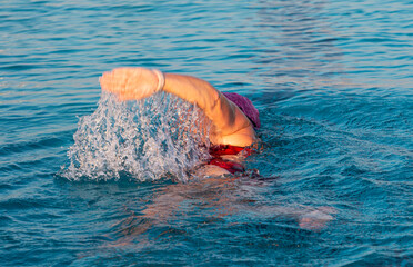 Rear view of close up of swimmer splashing in a pool