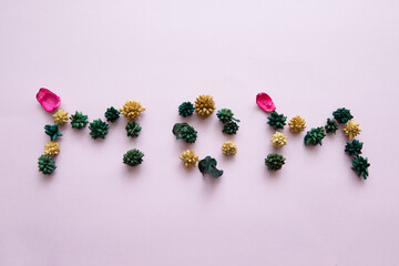 Writing MOM in flowers on light background. card mothers day flowers top view