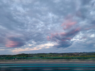 Pink sky before sunset. Cumulus clouds.