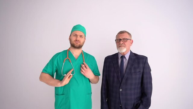 Labor Day. A young doctor with a phonendoscope and a mature businessman in a business suit are standing nearby. Cooperation of different professions