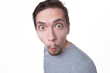 Emotions concept. Portrait of shocked male with small beard says wow, looks bugged eyes and rounded mouth, being amazed to see something unexpected. Terrified guy with surprised expression.
