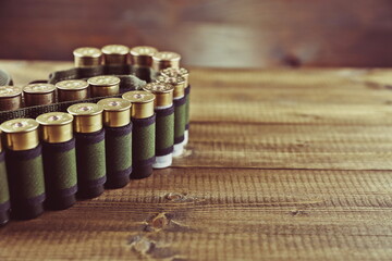 bandolier with rifle cartridges on wooden background 