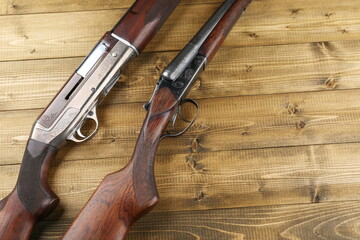 hunting rifles on a wooden background, top view with copy space. 