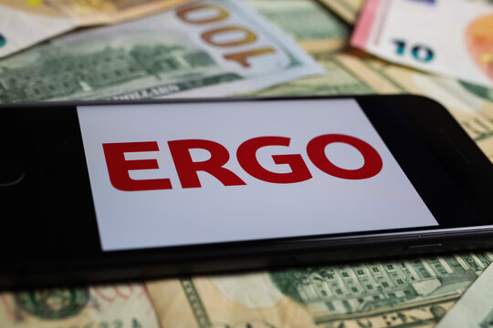 Viersen, Germany - March 1. 2021: Closeup of smartphone with logo lettering of ergo insurance company on paper money currency