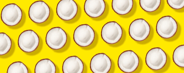 Ripe coconuts pattern on yellow background. Flat lay, top view. Summer concept.