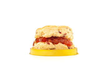Scone traditional English delicious freshly baked homemade with strawberry jam on isolated white background. Dessert, beverage, and relaxation concept