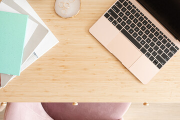 Top view of Wood office desk table with laptop and supplies, flat lay.