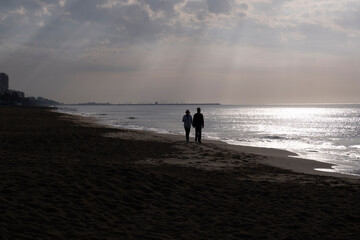 people enjoying spring time on the beach while doing sports and strolling along the water's edge 