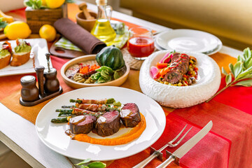 Served table in a restaurant with meat dishes