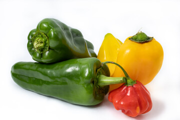 Group of different types and sizes of red, yellow and green peppers