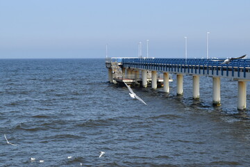 Fototapeta na wymiar Long pier on the shores of the baltic sea.