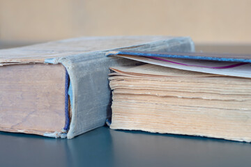 Two old shabby books on the table close-up.
