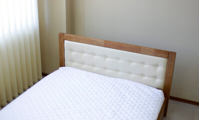 lacquered wooden double bed with a soft headboard