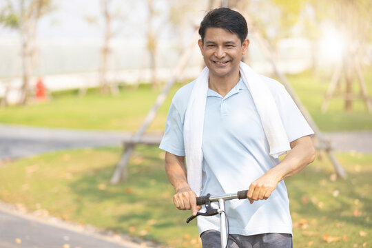 Portrait Senior Asian Man Riding Electric Scooter For Workout