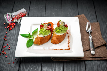 Bruschetta with avocado, prosciutto and sun-dried tomatoes