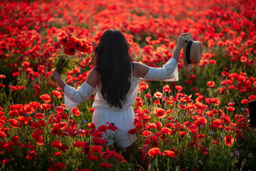the girl walks in the poppy field