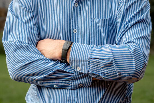 SHEFFIELD, UK – OCTOBER 12, 2019: A man in a shirt wearing a Philips Respironics Actiwatch, a clinical research-grade tracker watch for insomnia, sleep studies and activity monitoring