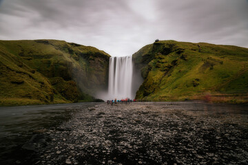 Fototapeta na wymiar Iceland waterfall Skogafoss in Icelandic nature landscape. Famous tourist attractions and landmarks destination in Icelandic nature landscape on South Iceland.