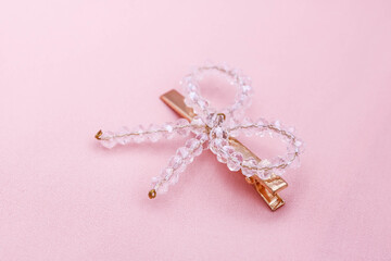 Luxury hair clips on pink fabric with copyspace.