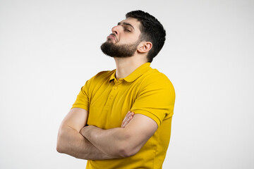 Angry offended man keeping arms crossed and staring at camera with sceptical and distrustful look,...