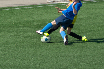 Children's football. Children are playing football. The active struggle and dynamics of the boys' soccer match. The boys are recklessly fighting for the ball