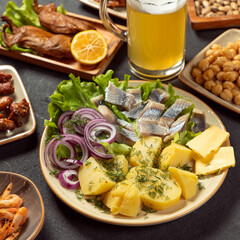 Grilled salted fish with potato and onion close up