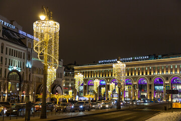 Fototapeta na wymiar MOSCOW, RUSSIA - JANUARY 6, 2021: Night view of Lubyanskaya square with illuminated Central Children's Store on Lubyanka on background.