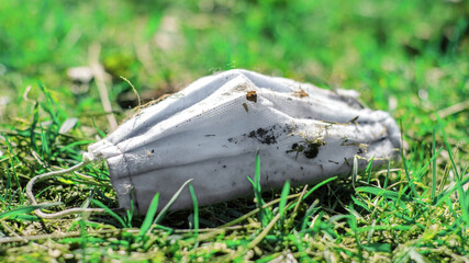 Dirty medical mask on the ground