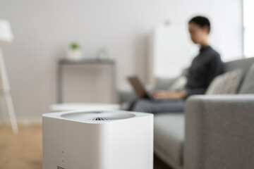 African American Woman Using Air Cleaner